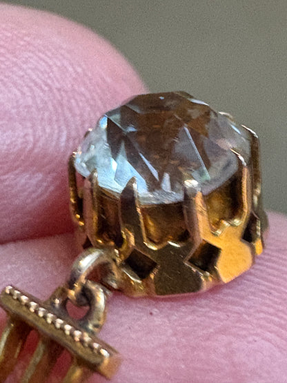 Antique Victorian pendant with rock crystal quartz in a gold setting on a gold chain.