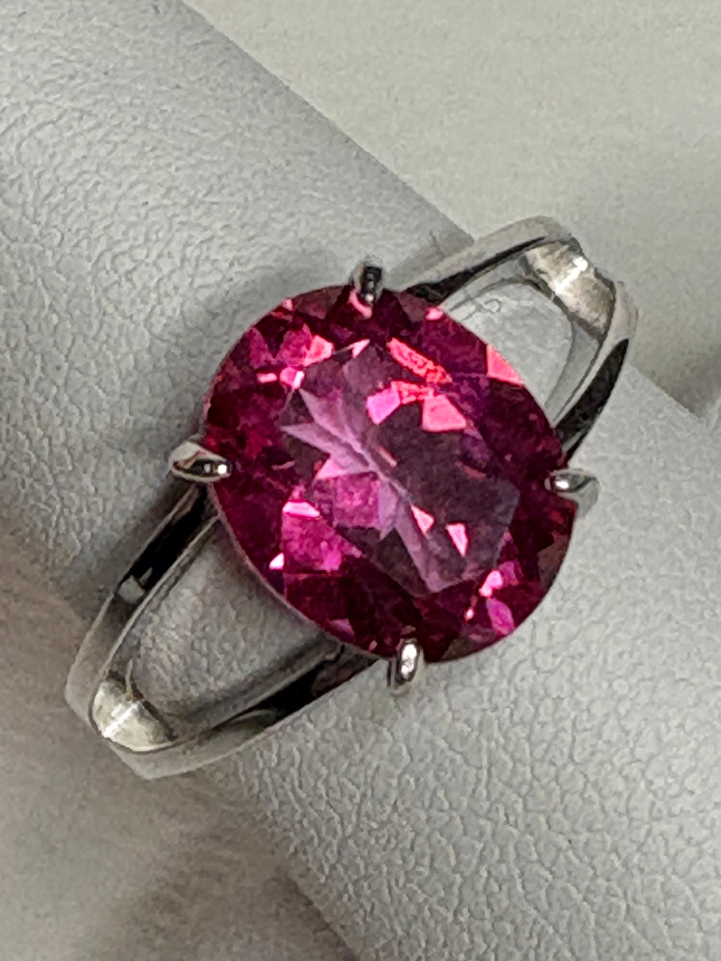 Large oval pink topaz solitaire ring with split shank in sterling silver.