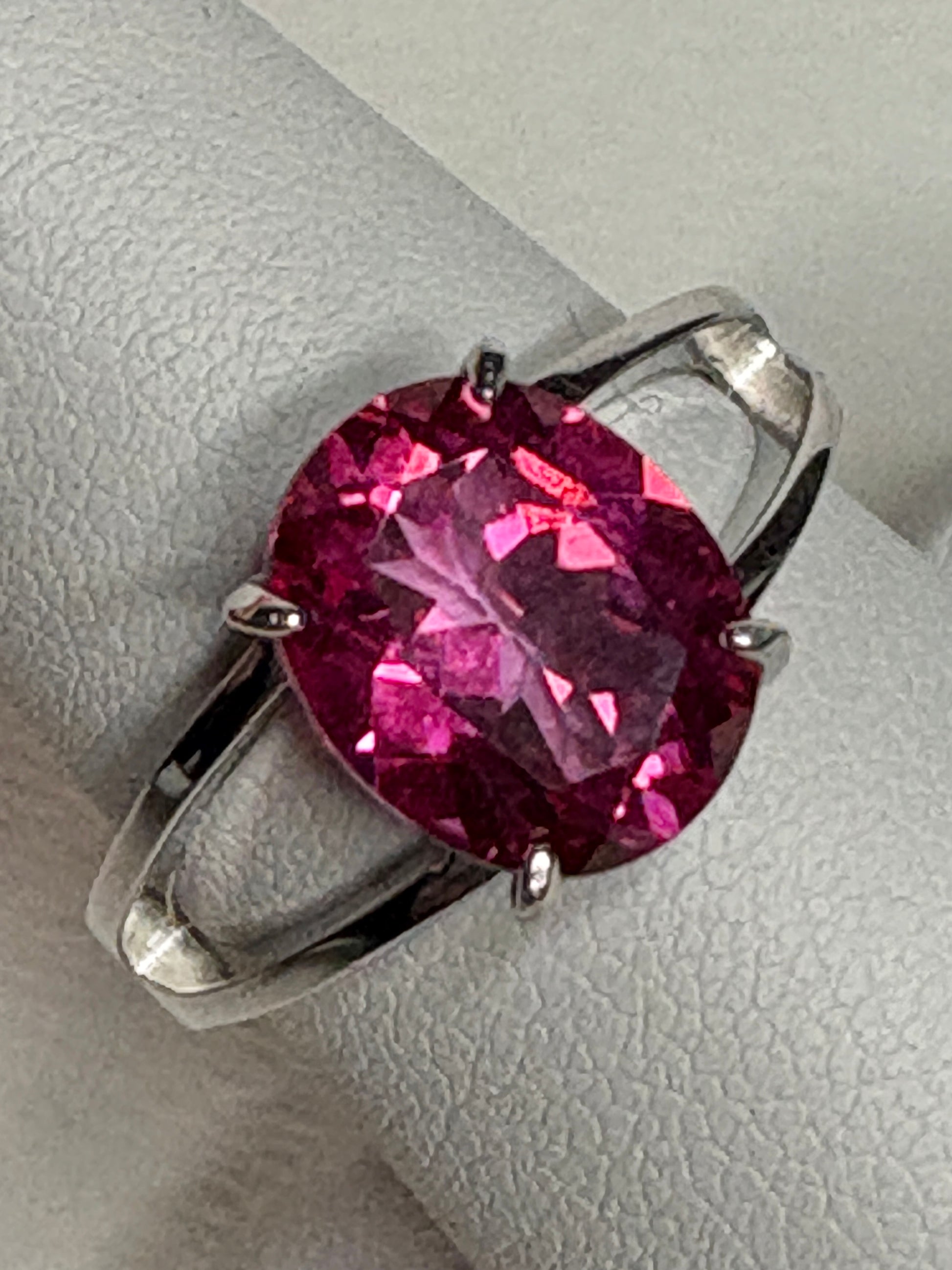 Large oval pink topaz solitaire ring with split shank in sterling silver.