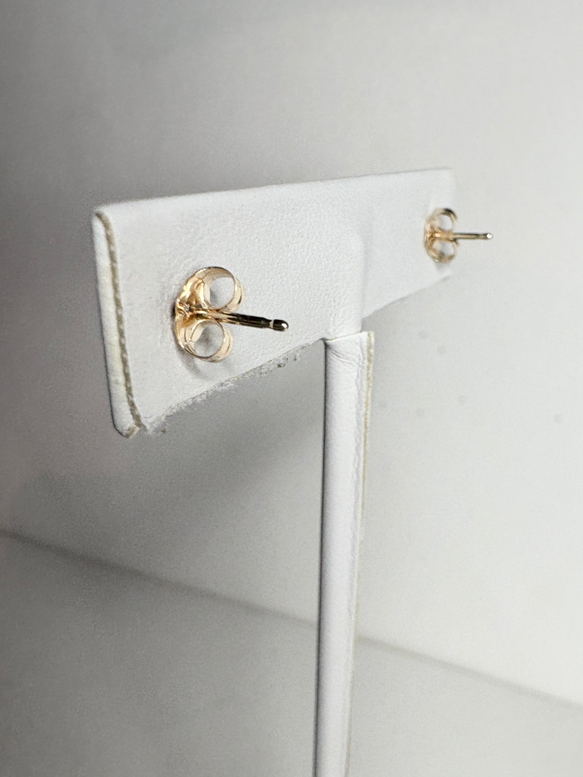 Solid 14k gold stud earrings with diamond backs.
