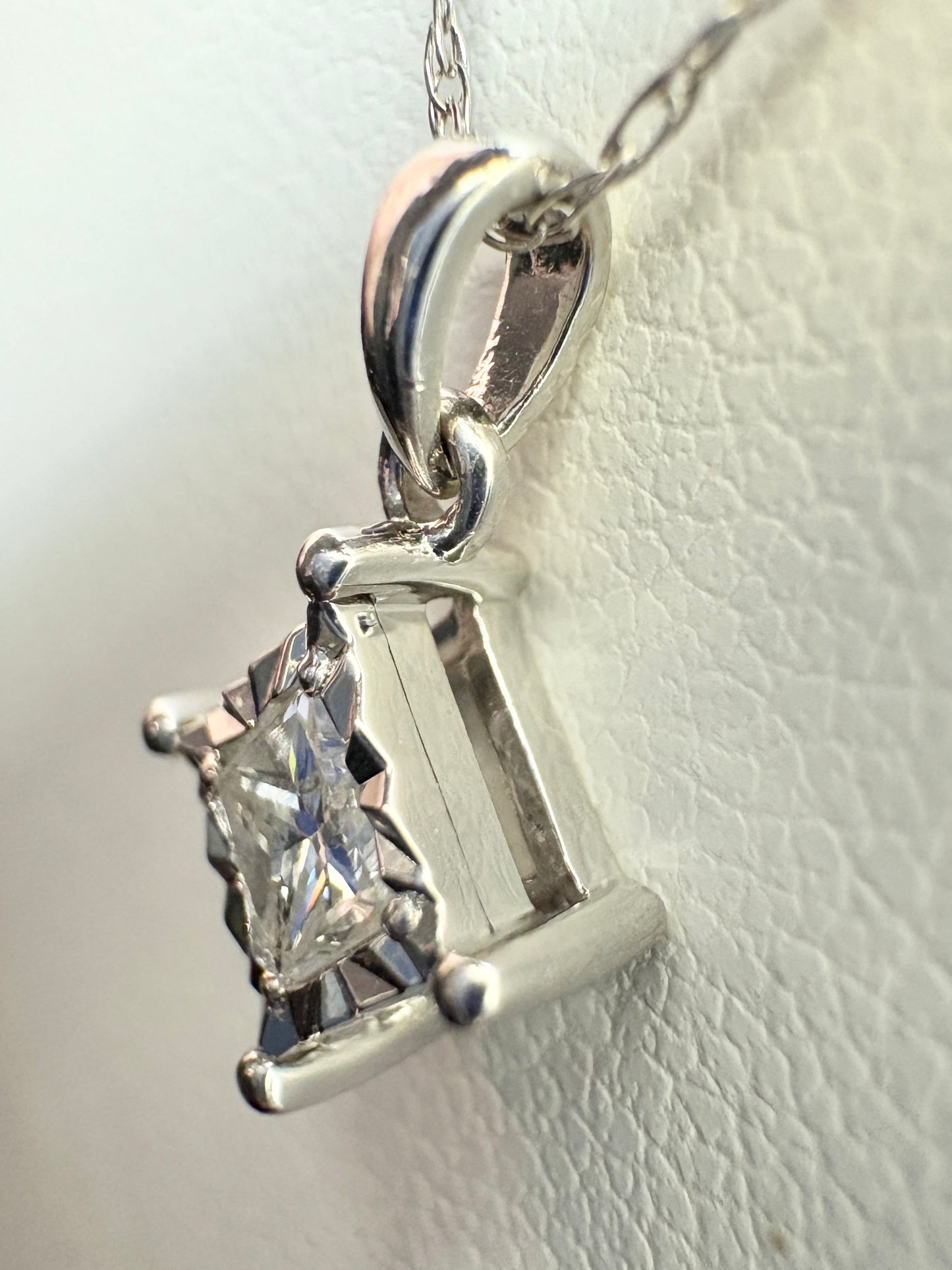 A princess cut diamond pendant necklace on a 10k white gold chain.