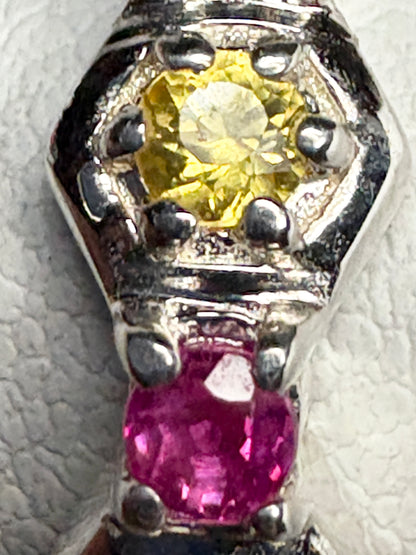 Sterling silver ring with honeycomb pattern, featuring a yellow sapphire and a pink ruby.