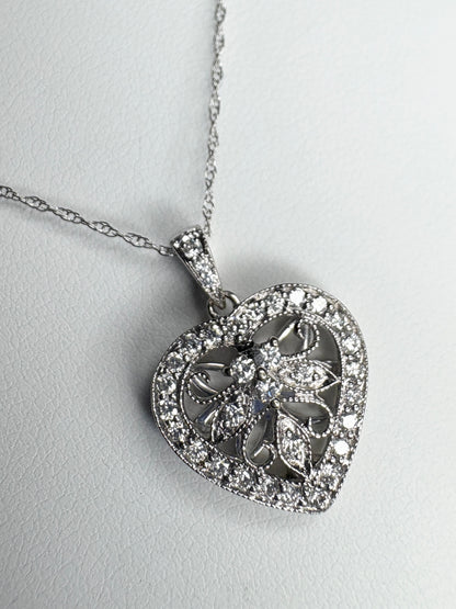 A white gold heart pendant necklace with natural diamonds.