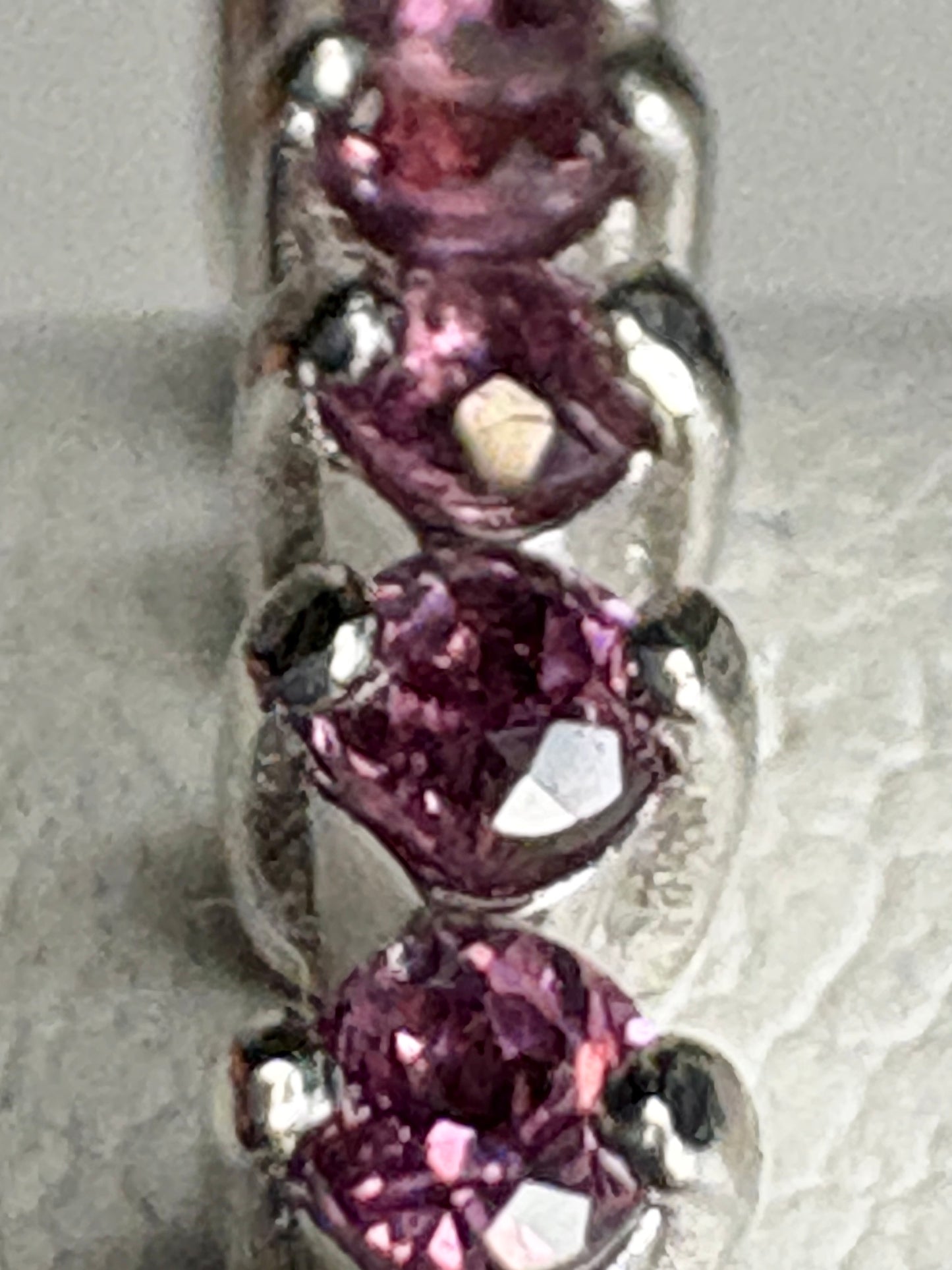 Sterling silver band ring with three rhodolite garnets.