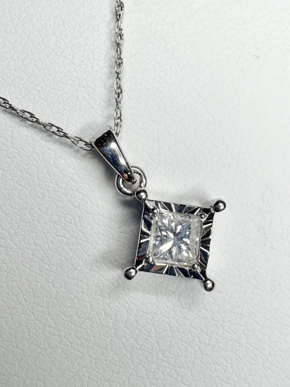 A princess cut diamond pendant necklace on a 10k white gold rope chain.