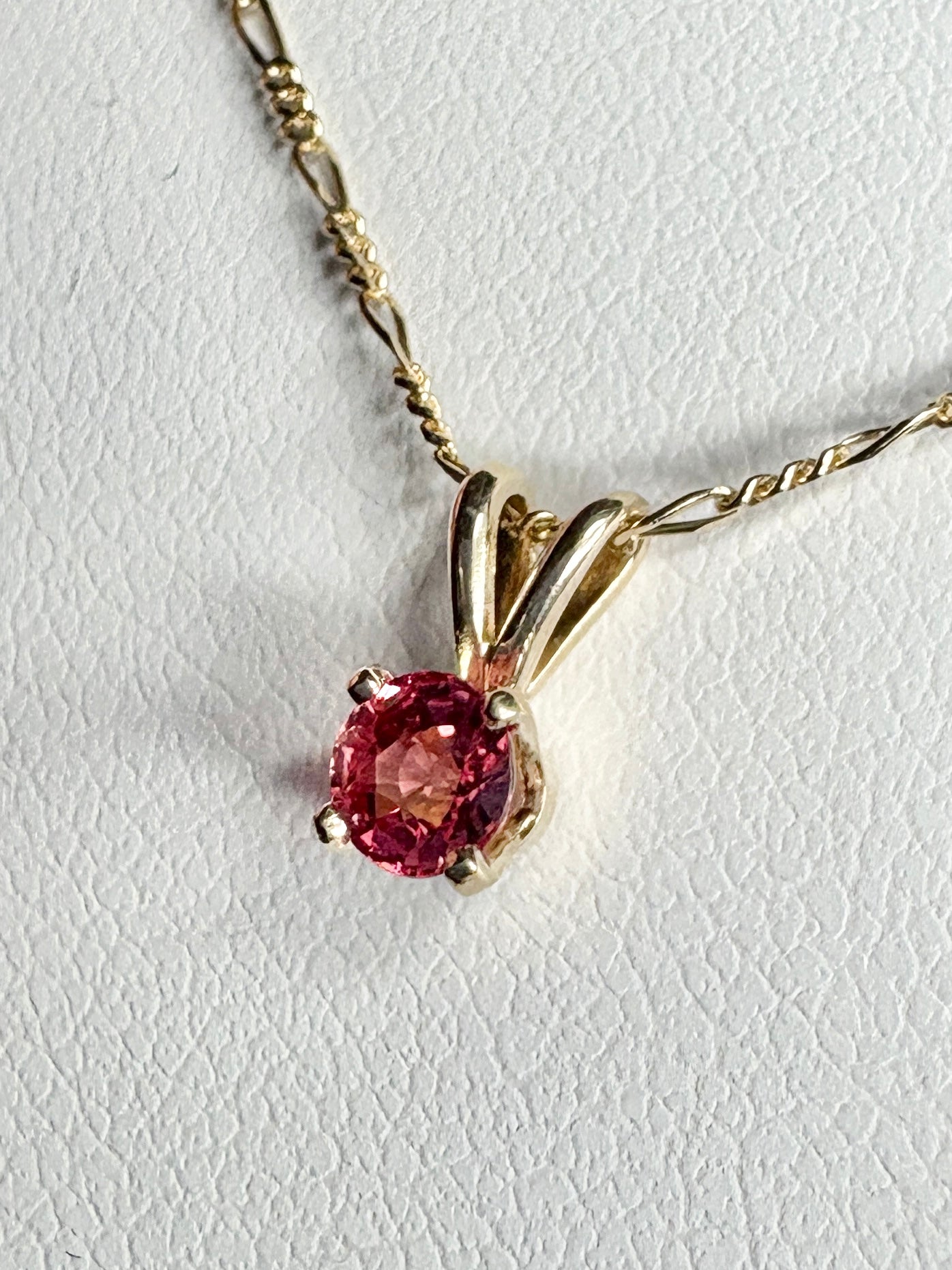 Small padparadcha sapphire solitaire pendant necklace in solid 14k gold.