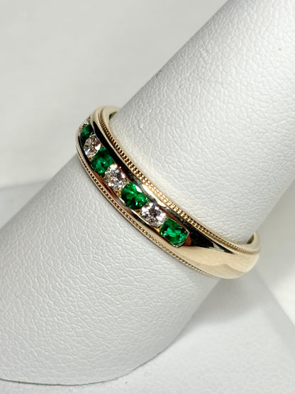 18k gold band ring with alternating emeralds and diamonds.