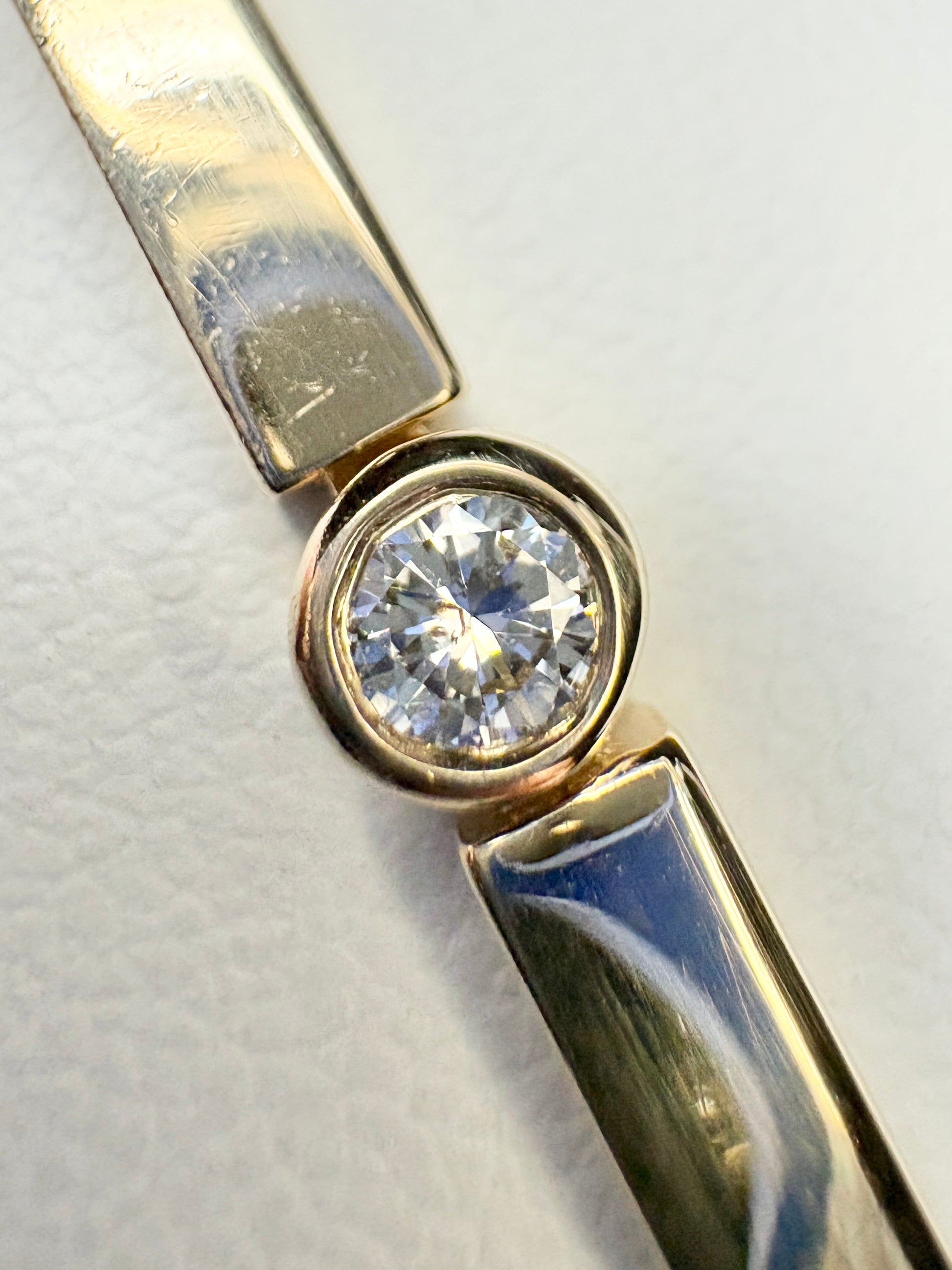 Bezel set natural diamond tennis bracelet in solid 14k gold.