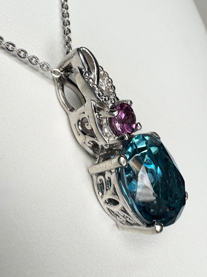 Sterling silver pendant necklace with oval London blue topaz and round rhodolite garnet.