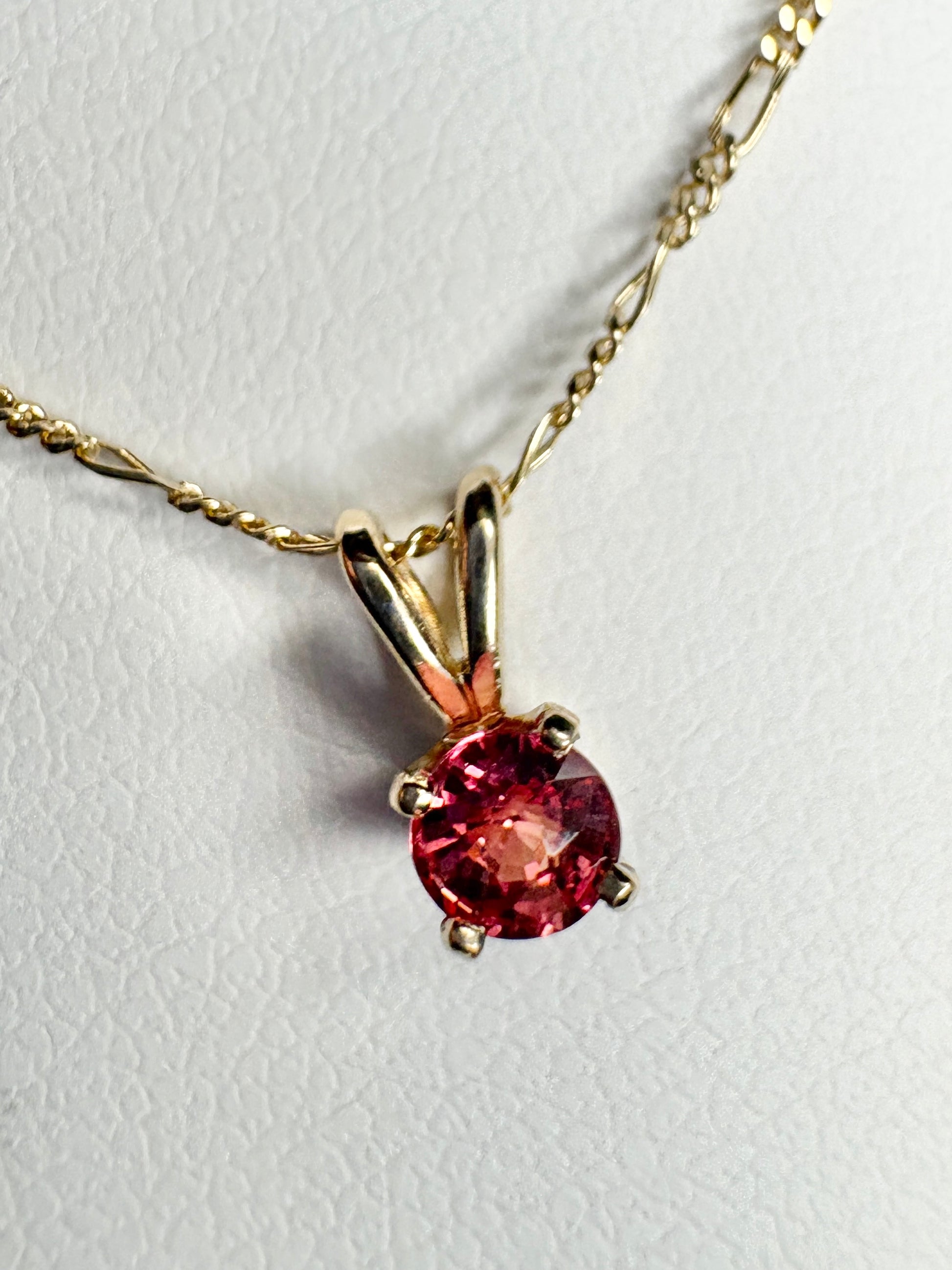 Small padparadcha sapphire solitaire pendant necklace in solid 14k gold.