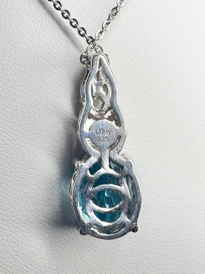 Sterling silver pendant necklace with a blue topaz and rhodolite garnet.