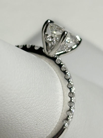 A 14k white gold engagement ring with a large center diamond and smaller accent diamonds.