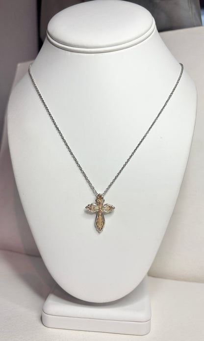 Black Hills Gold ornate cross pendant with sterling silver frame on a stainless steel chain.