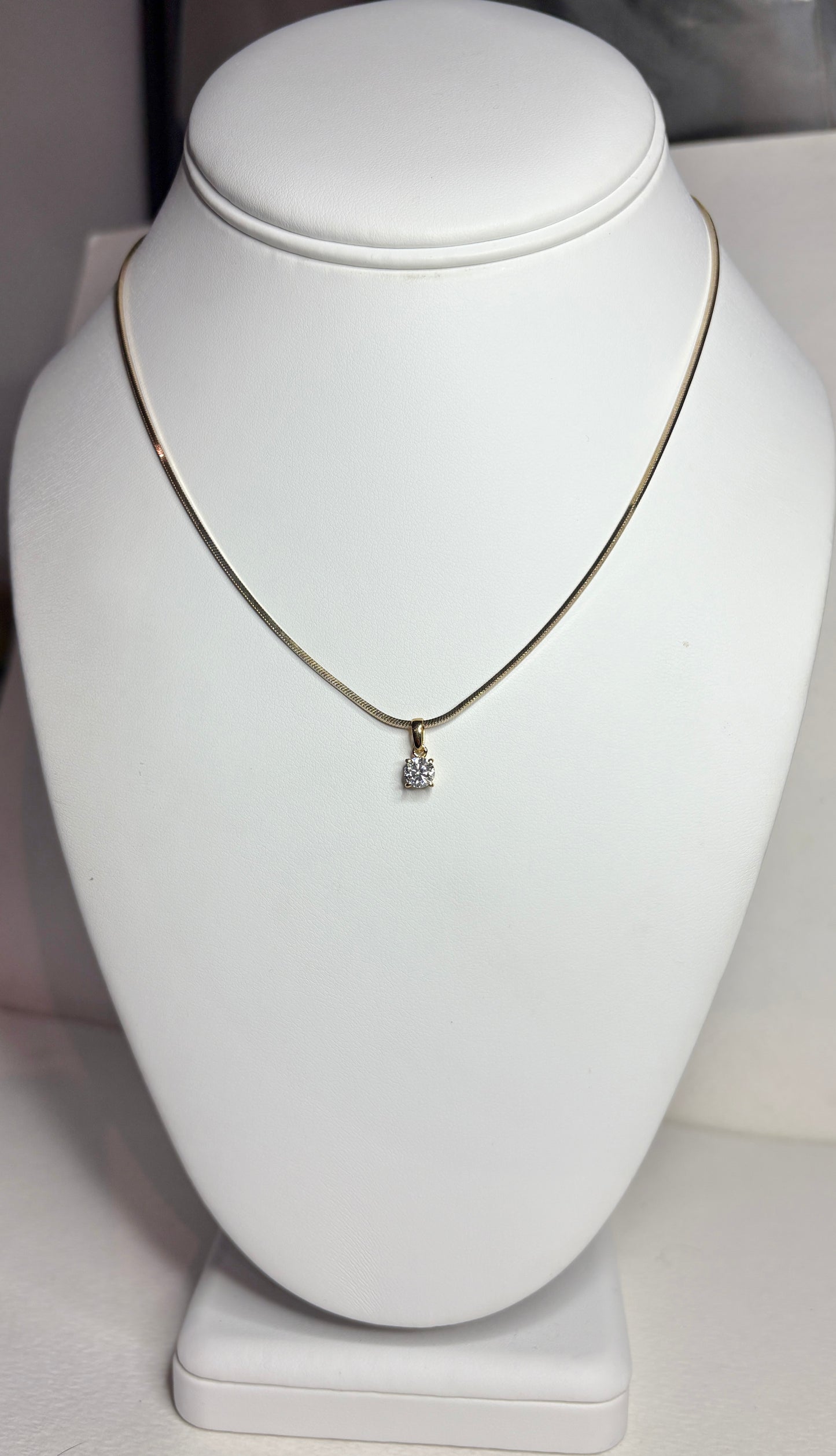 Gold over sterling silver necklace with a moissanite solitaire pendant.