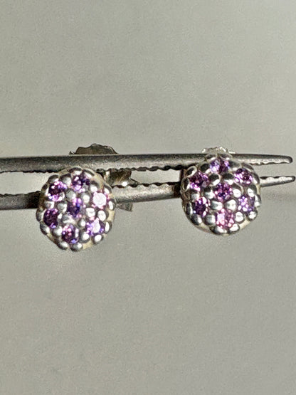 Sterling silver stud earrings with pave-set violet purple cubic zirconia stones.