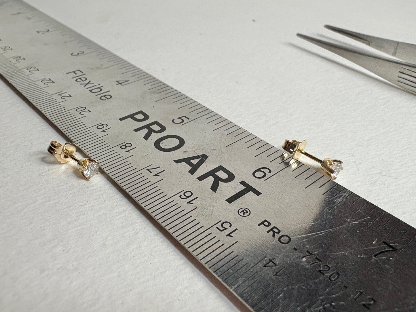 Natural diamond solitaire stud earrings in solid 14k gold.