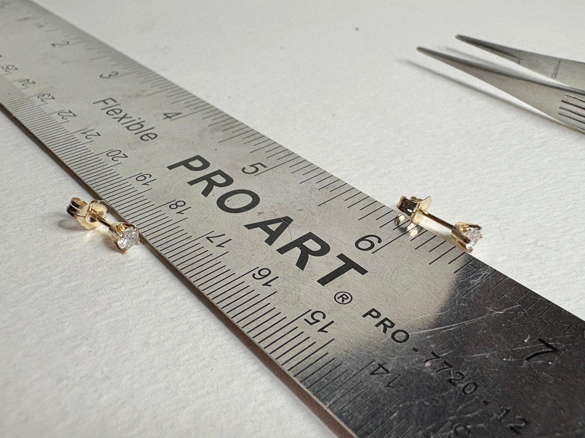 Natural diamond solitaire stud earrings in solid 14k gold.