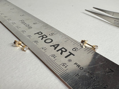 Natural diamond solitaire stud earrings in solid 14k gold.