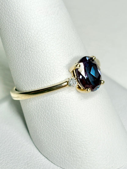 Oval lab-grown alexandrite and diamond ring in 10k gold.