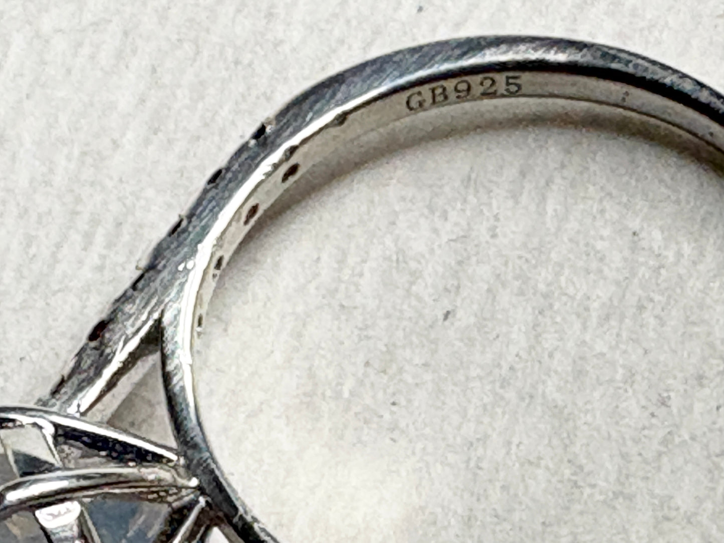 Sterling silver ring with "GB925" stamp and small stones.