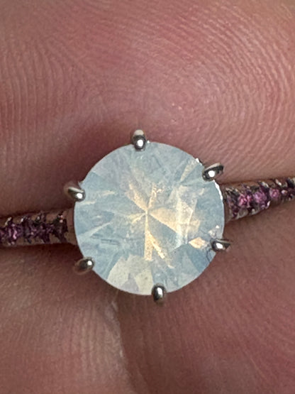 A sterling silver ring with a milky white quartz and rhodolite garnets.