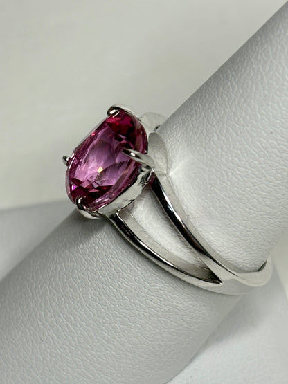 Sterling silver ring with a large oval pink topaz and split shank band.