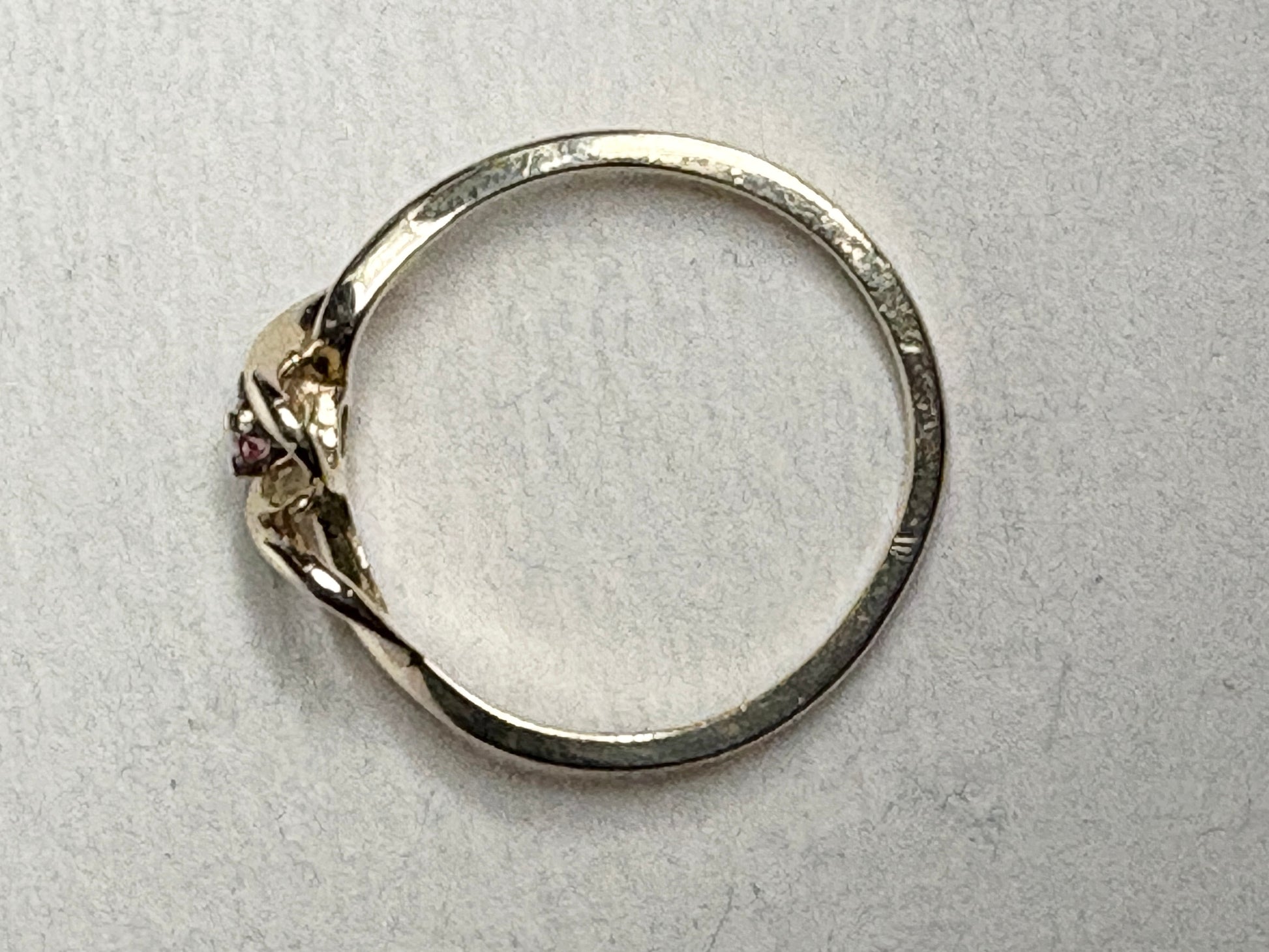 Ribbon style ring in solid 10k gold with a natural bixbite red emerald.