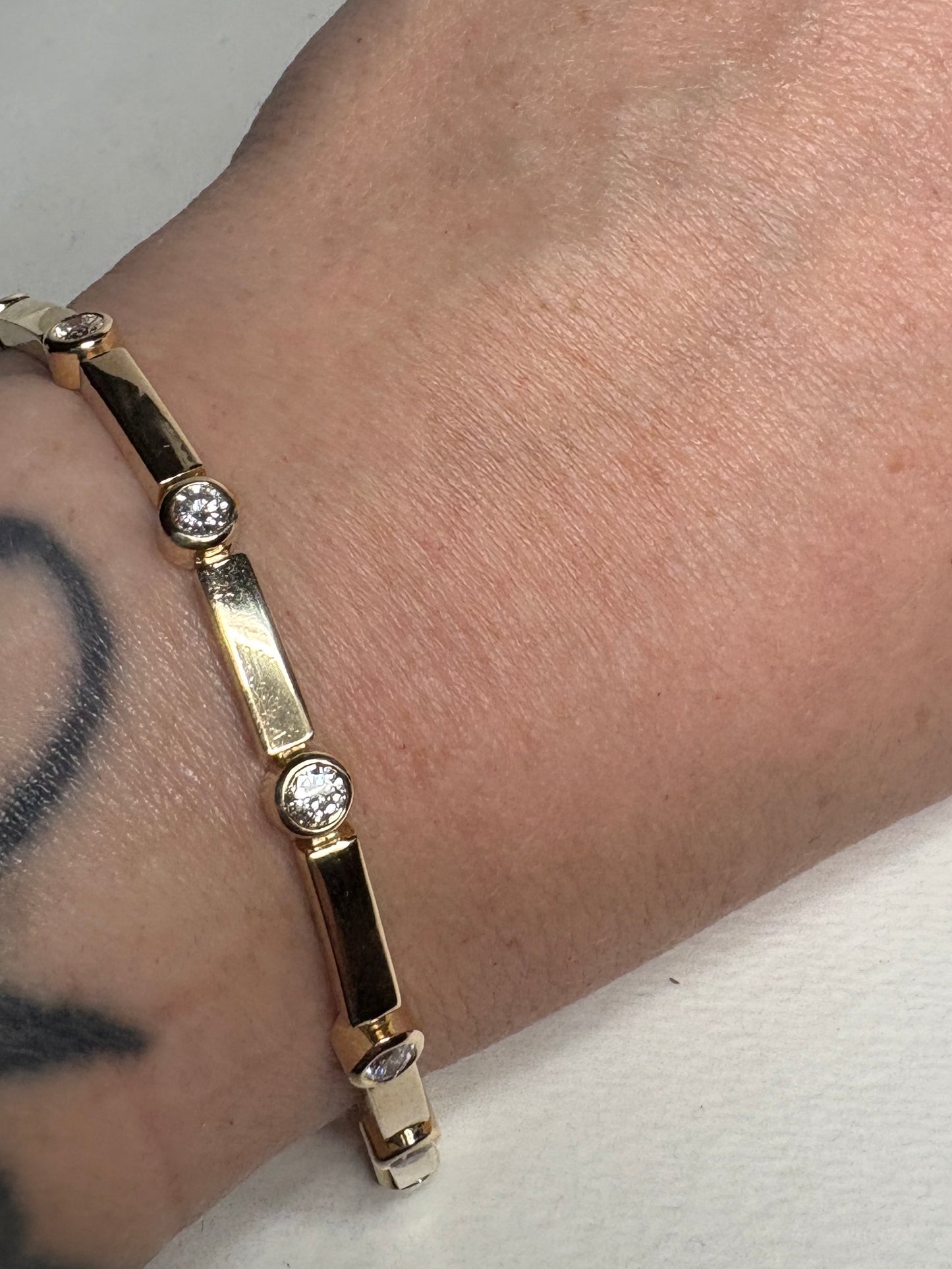 14k yellow gold bracelet with bezel-set diamonds.