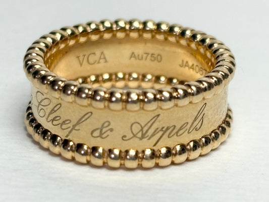 Van Cleef & Arpels 18k gold Perlee Signature band ring with engraved text.