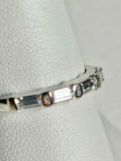 A 14k white gold band ring with baguette moissanite stones.