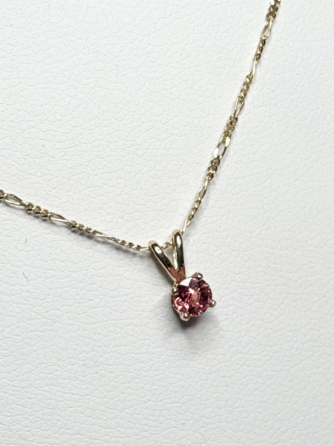 Small Padparadcha sapphire solitaire pendant necklace in solid 14k gold.