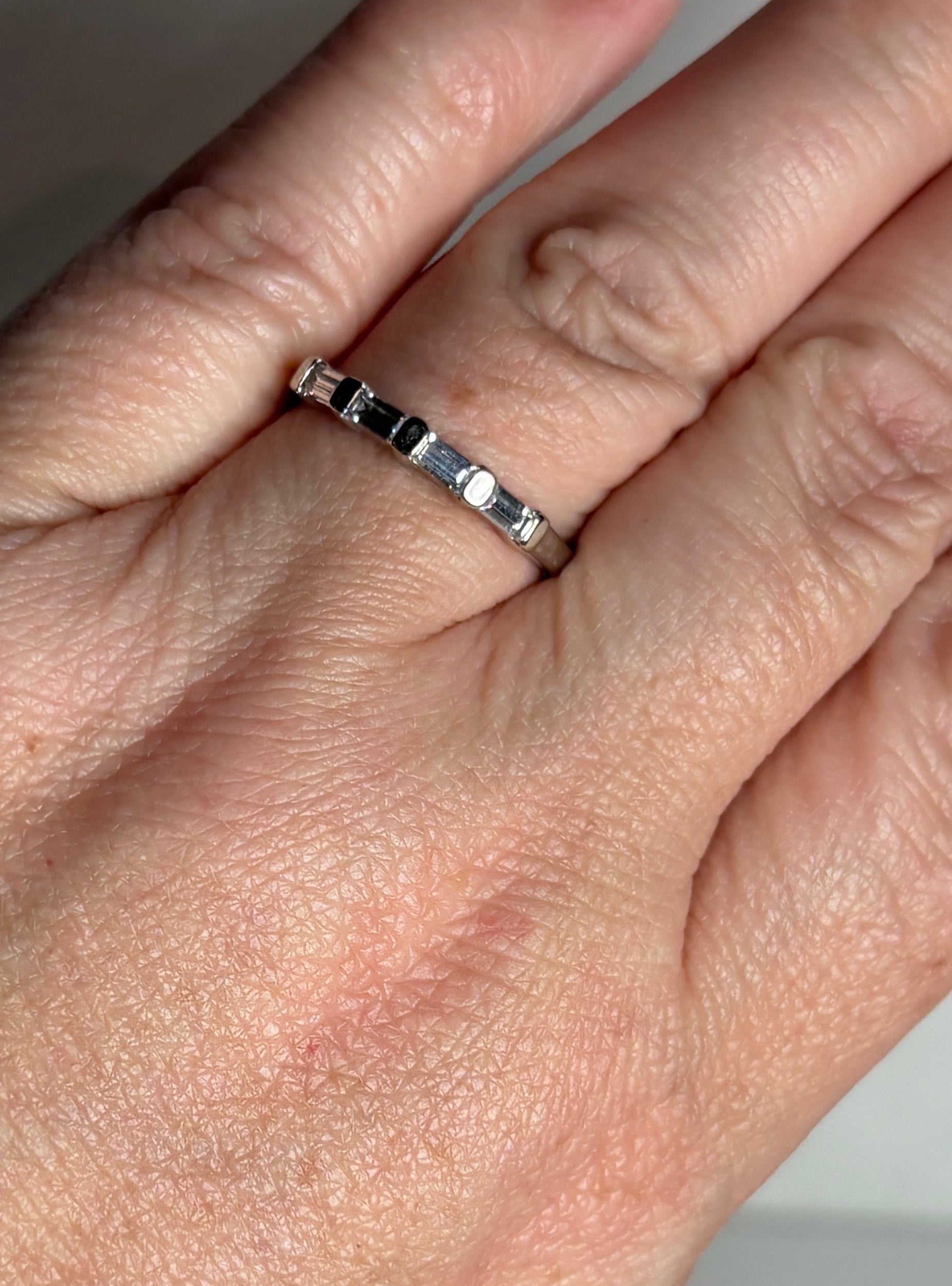 Charles and Colvard baguette moissanite stackable band ring in solid 14k white gold.