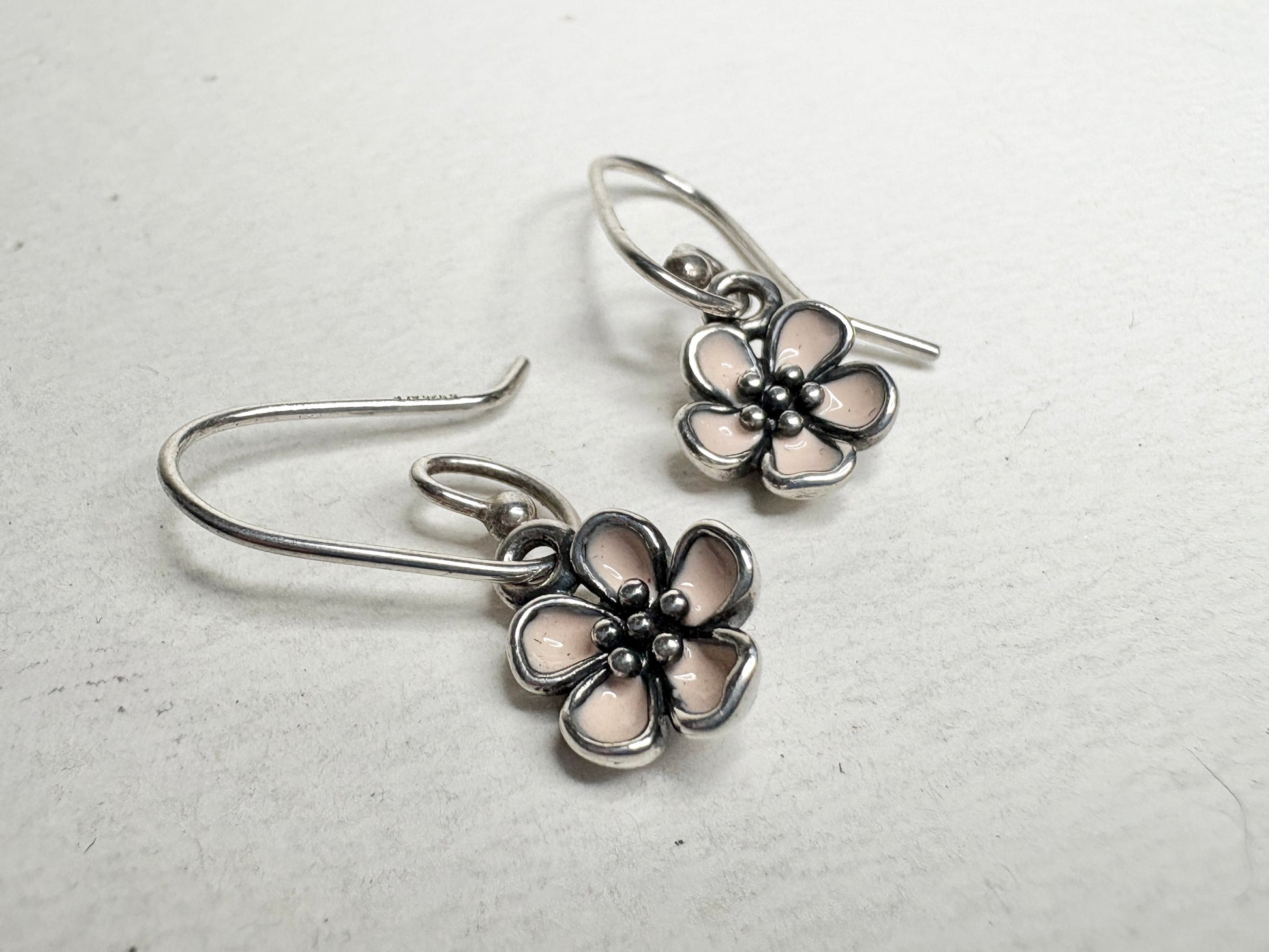Pandora sterling silver dangle earrings with pink enamel cherry blossom charms.