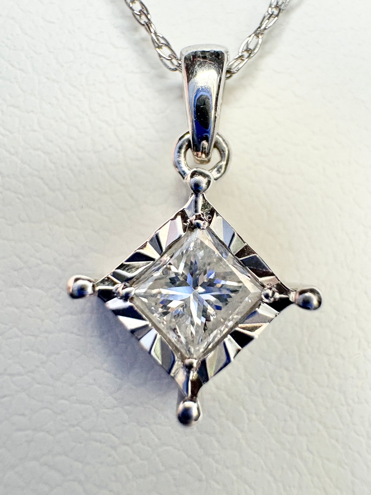 Princess cut diamond pendant necklace in 10k white gold.