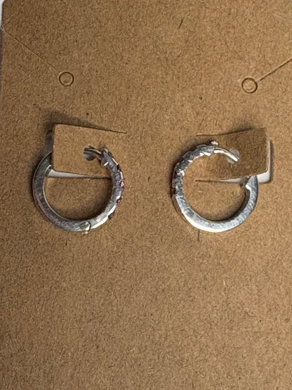 Sterling silver small huggie hoop earrings with rhodolite garnets.