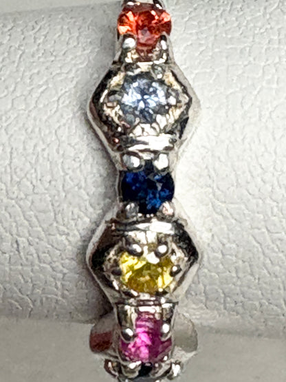 Sterling silver band ring with honeycomb shapes and colorful sapphires and ruby.