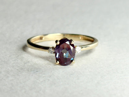 Oval lab grown alexandrite and diamond ring in 10k gold.