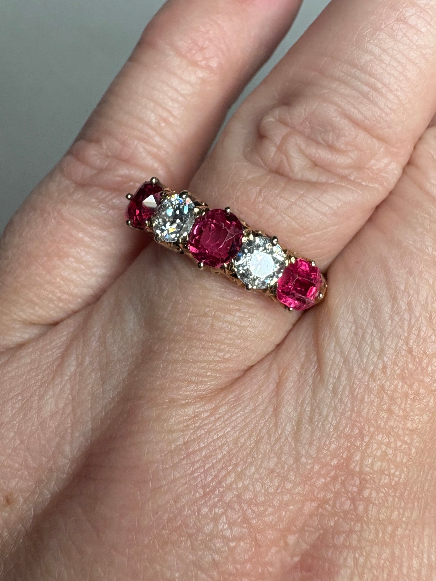 Antique 14k gold band ring with red spinels and old mine cut diamonds.