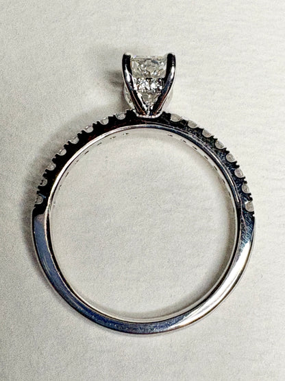 A 14k white gold engagement ring with a large center diamond and smaller accent diamonds.