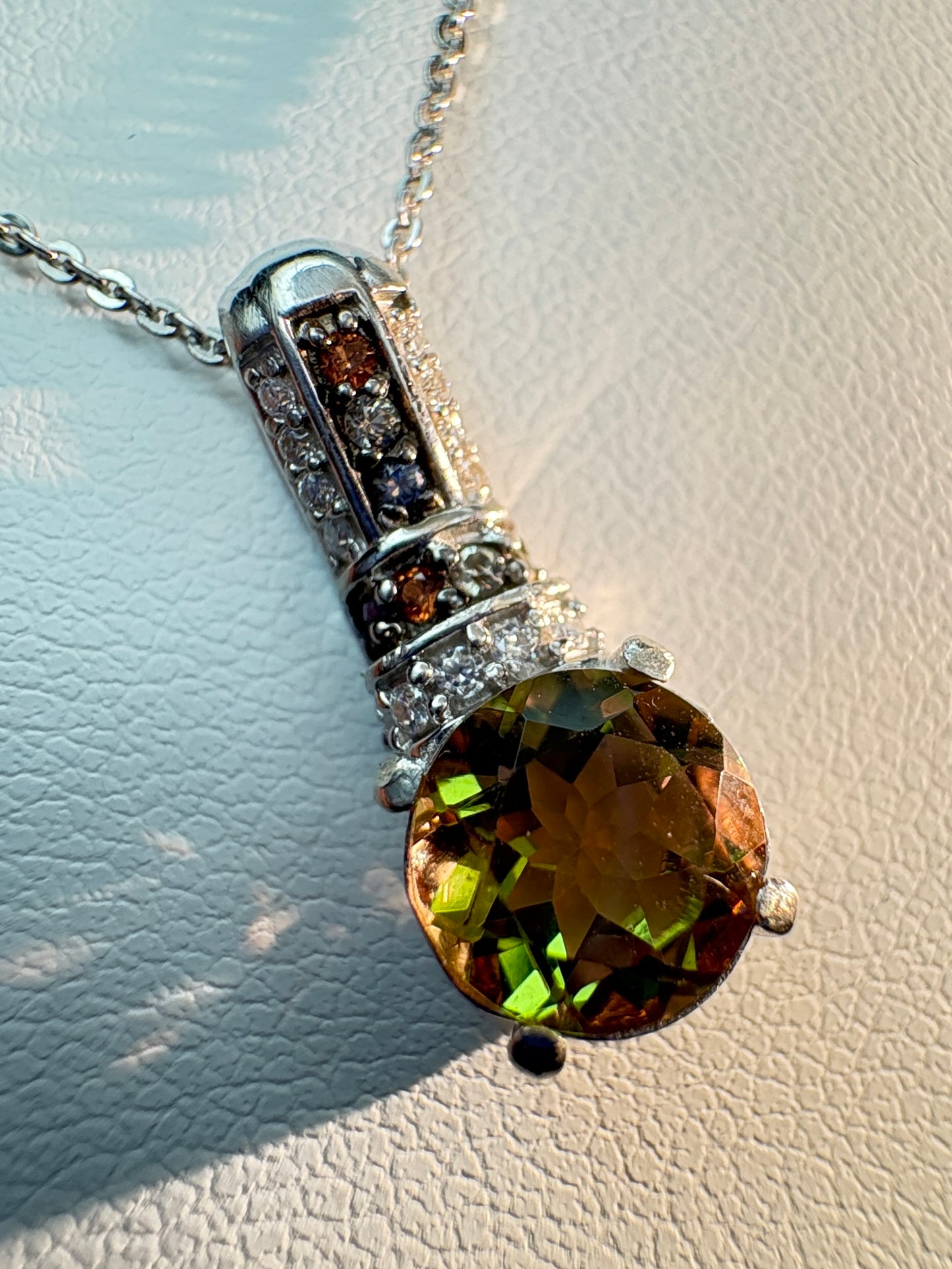 Sterling silver pendant necklace with color-changing glass, moissanite, and multi-color sapphires.