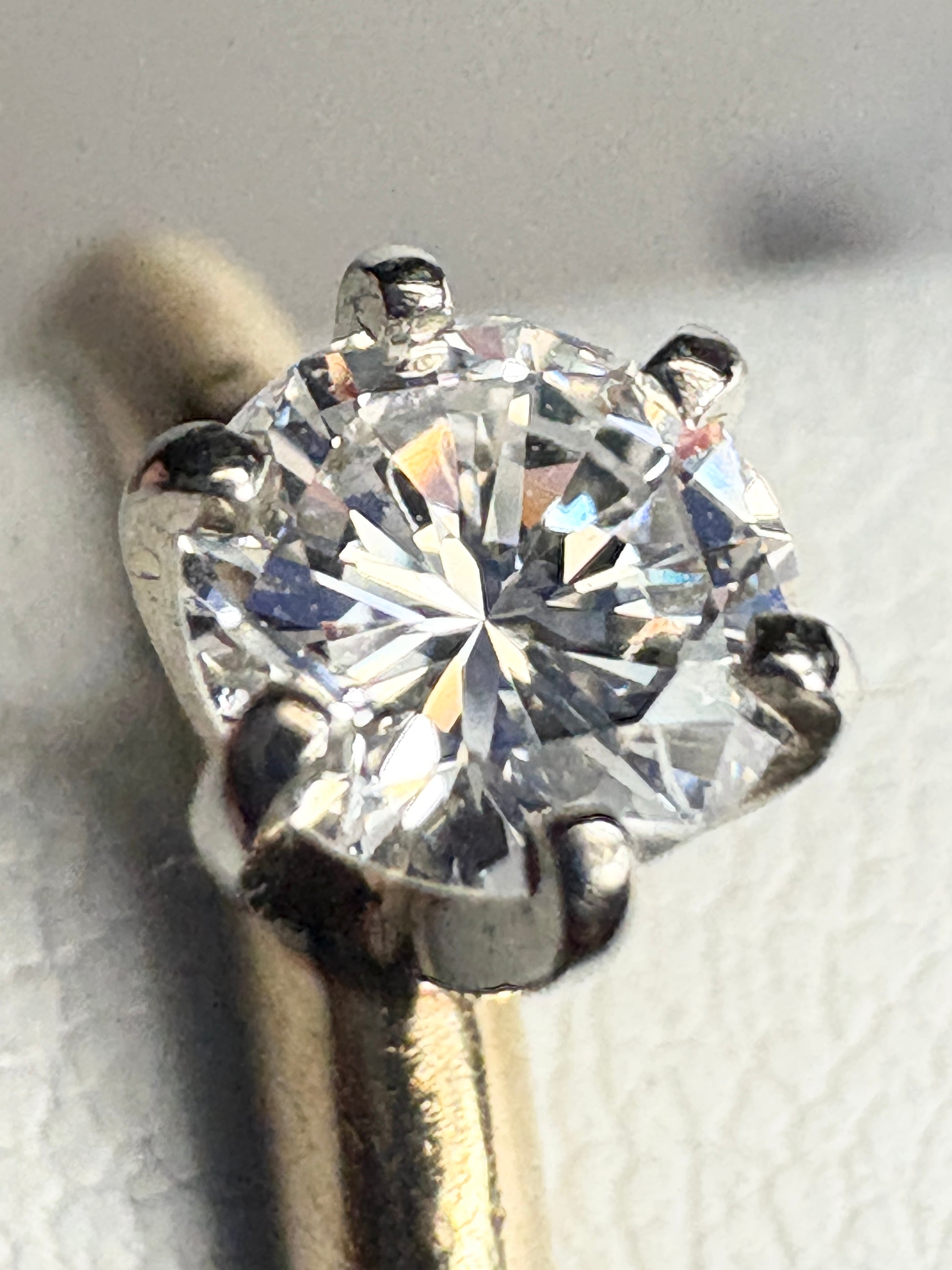 A natural diamond solitaire engagement ring with six prongs in 14k gold.