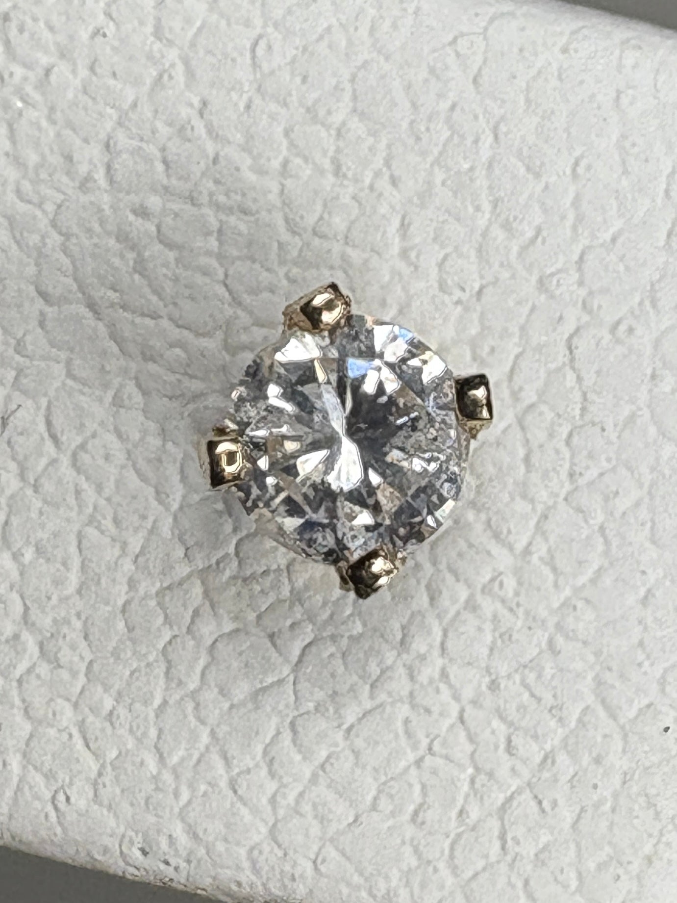 14k gold solitaire diamond stud earring with four prongs.