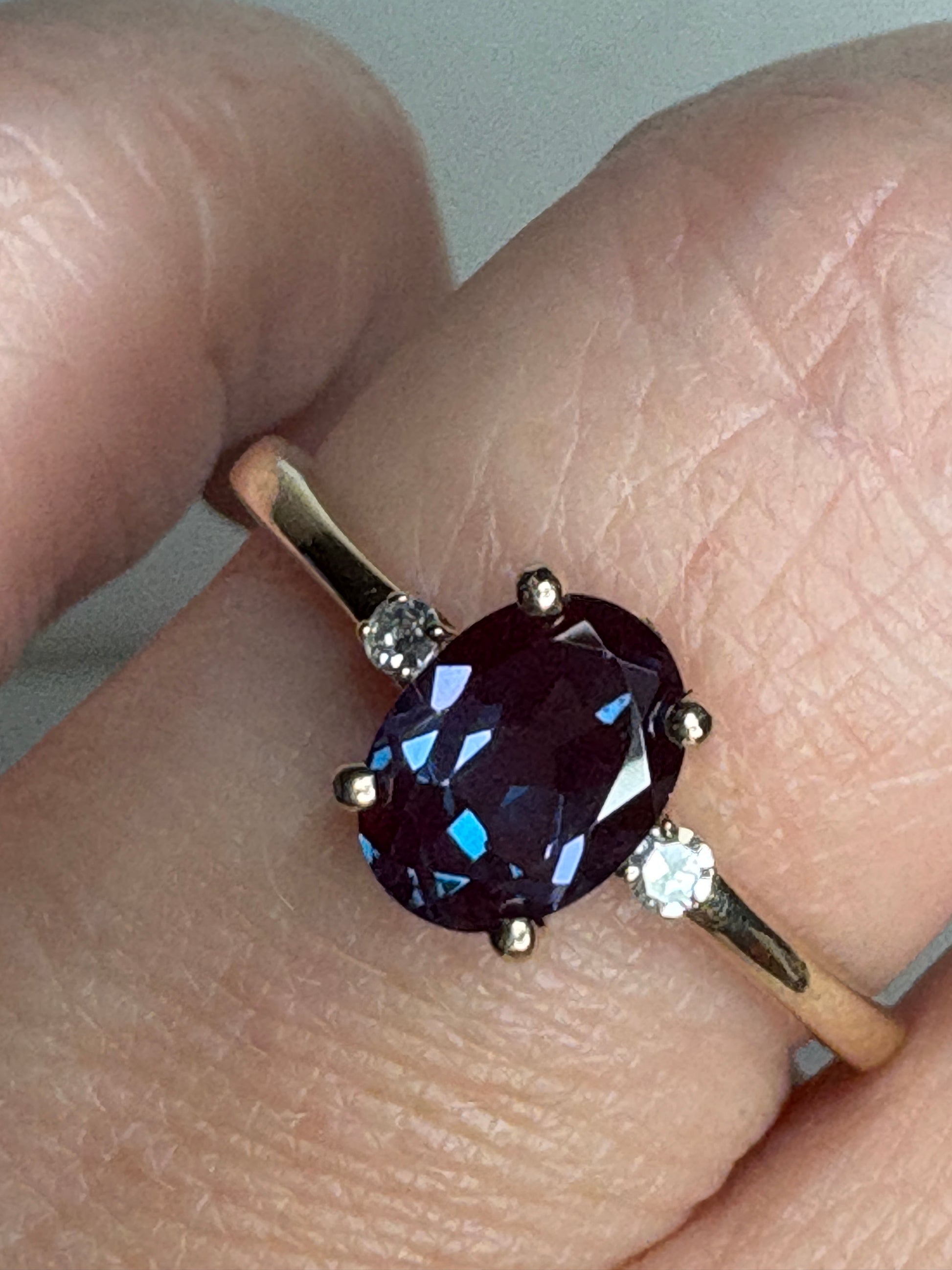 Oval lab grown alexandrite and diamond ring in 10k gold.