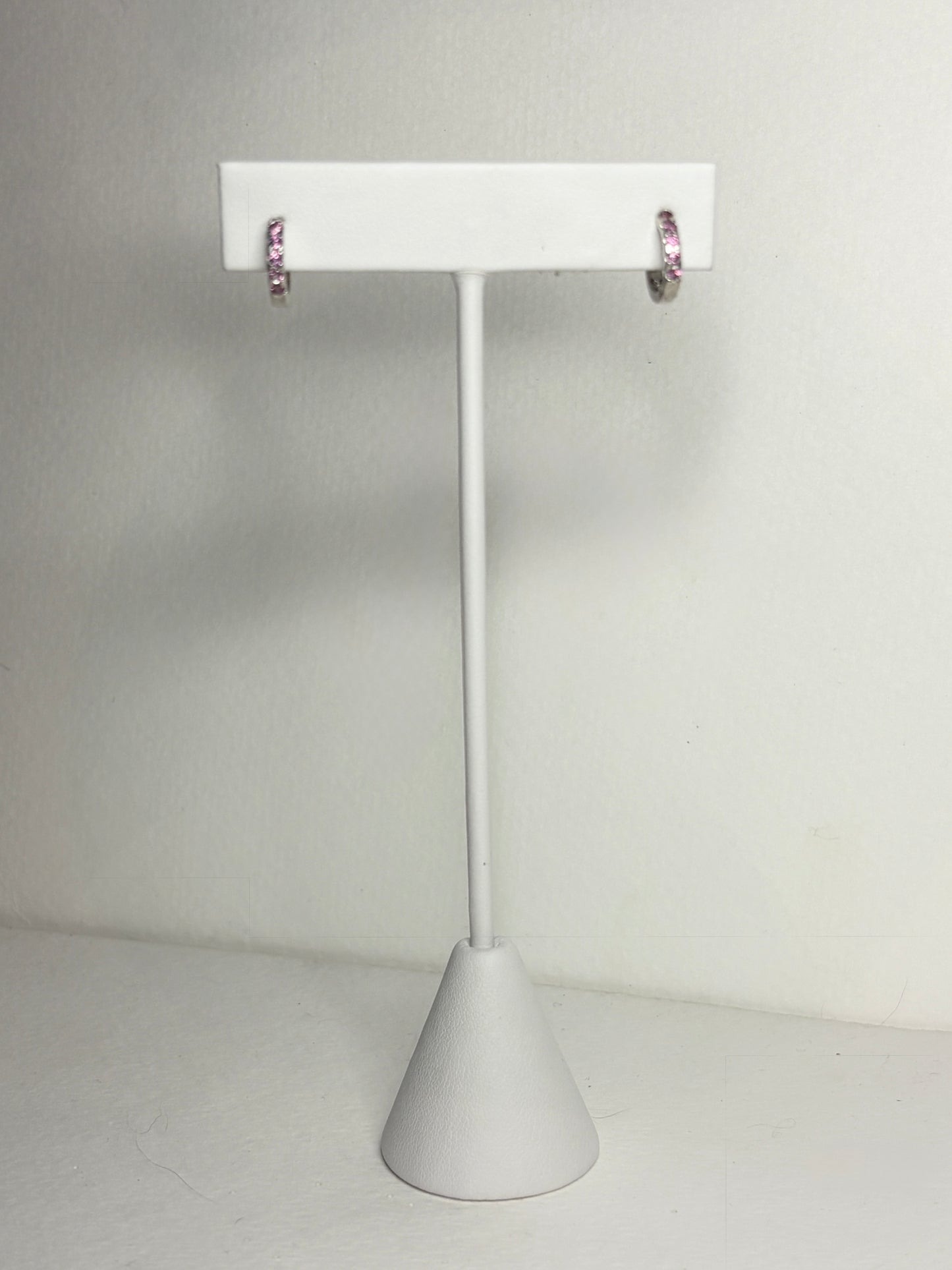 Sterling silver small huggie hoop earrings with rhodolite garnets.