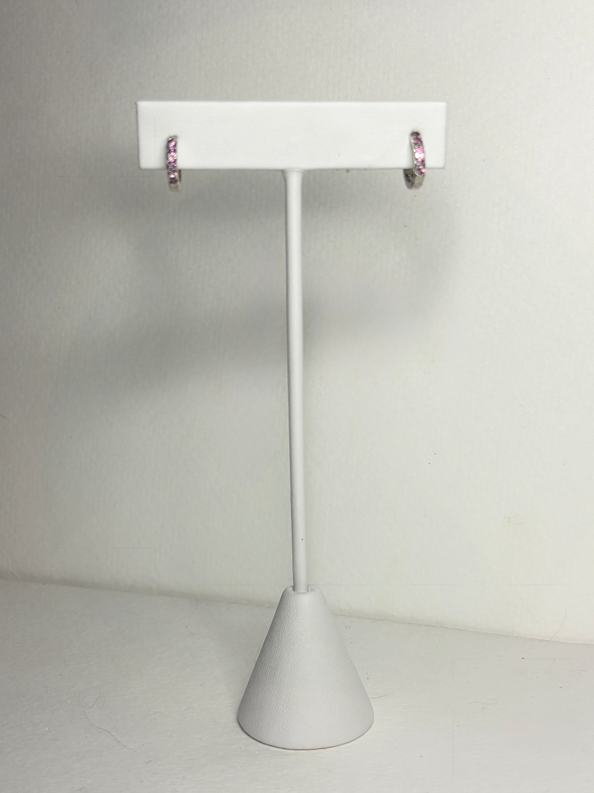 Sterling silver small huggie hoop earrings with rhodolite garnets.