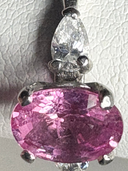 Platinum ring with pink sapphire and pear-shaped diamond.