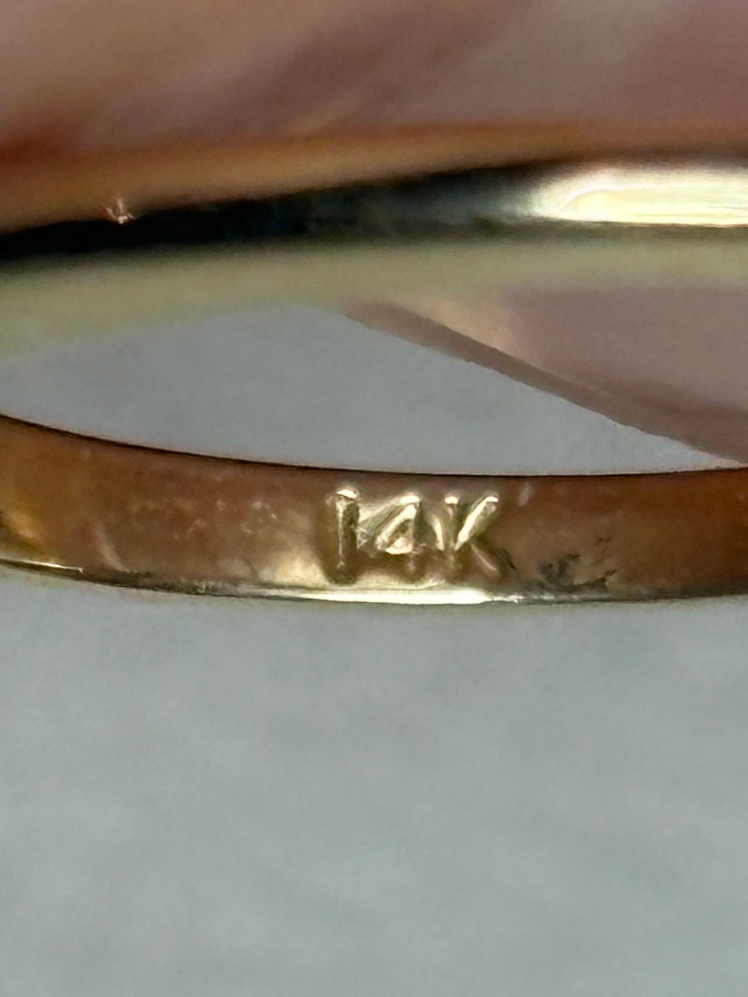 14k gold ring with a diamond marking.