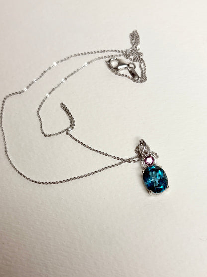 Sterling silver necklace with oval London blue topaz and round rhodolite garnet pendant.