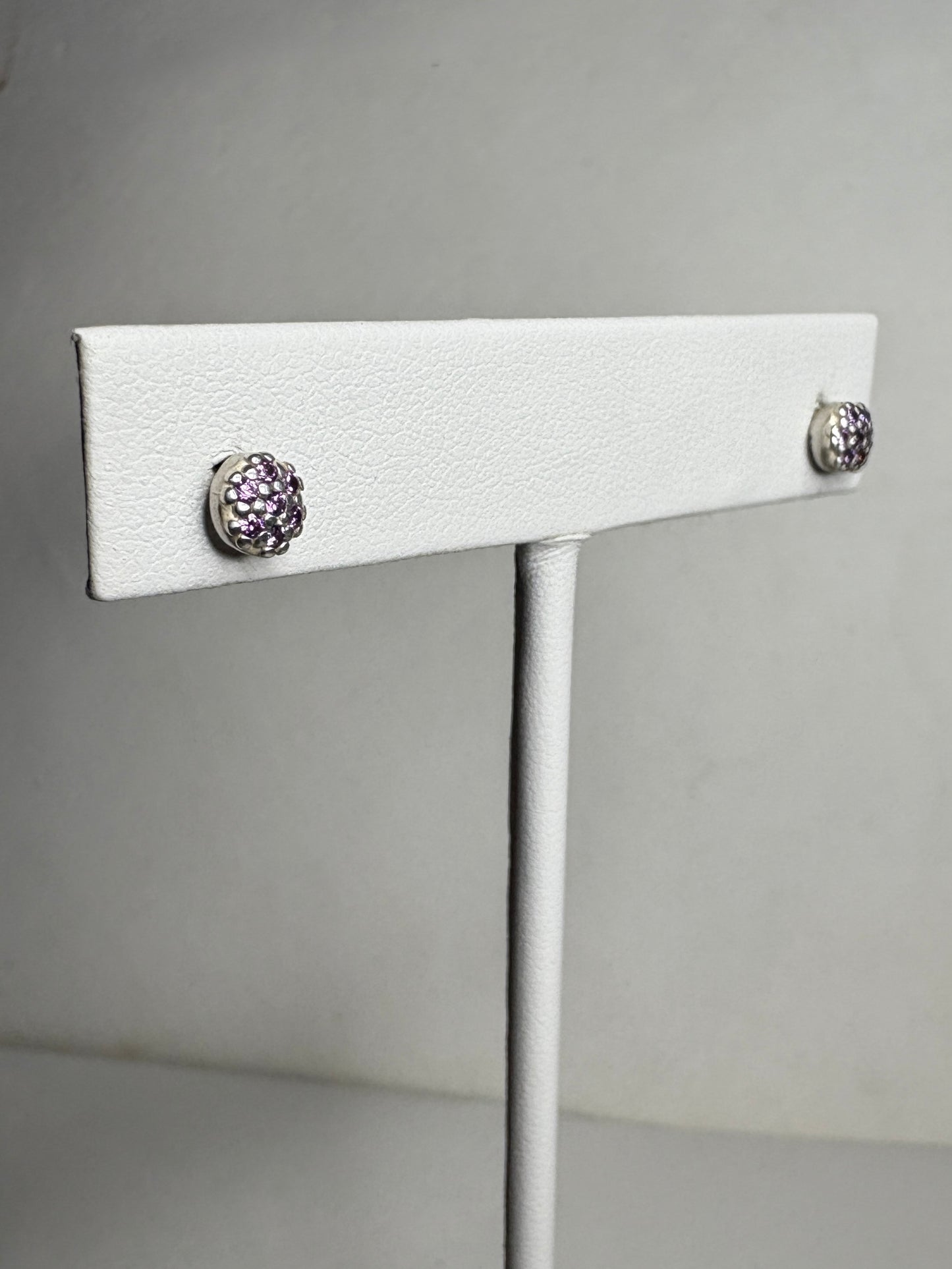 Sterling silver stud earrings with pave-set violet purple cubic zirconia stones.