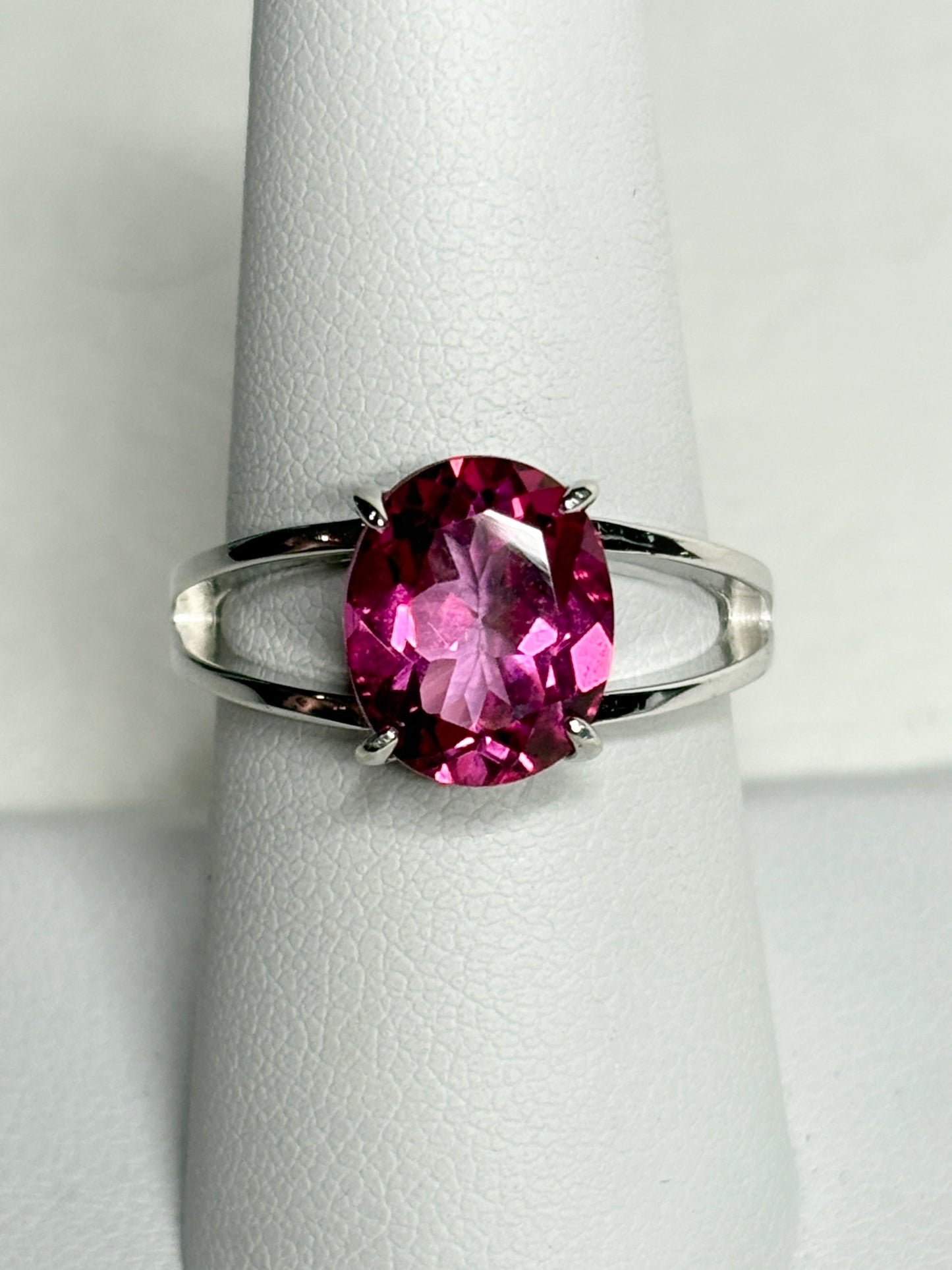 Sterling silver ring with a large oval pink topaz solitaire and split shank.